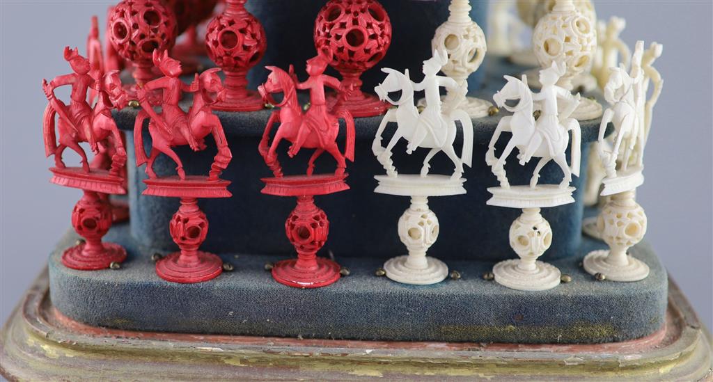 A set of 19th century Cantonese carved and red stained ivory chess pieces under dome, white king 20cm high
